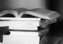 A monochrome image of a tall stack of books symbolizing education and knowledge.